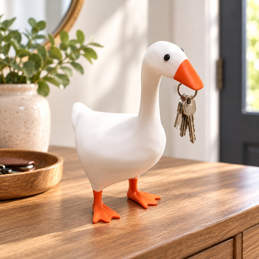White magnetic duck key keeper holding a ring of house keys