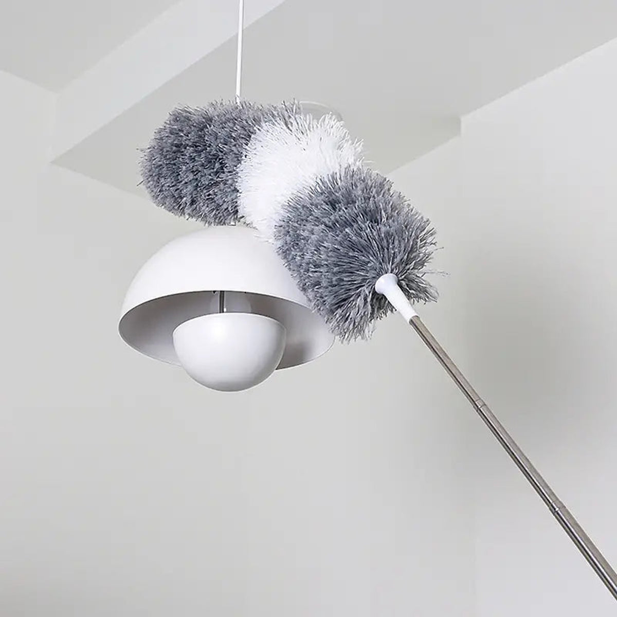 Retractable microfiber duster cleaning a high ceiling light